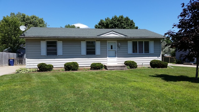 ranch-style house with fence and a front yard