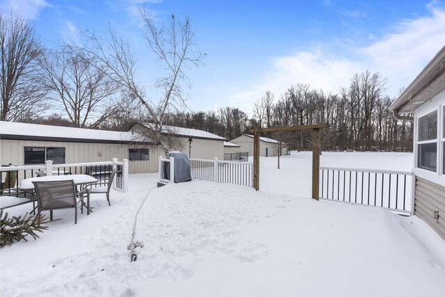 yard covered in snow featuring fence