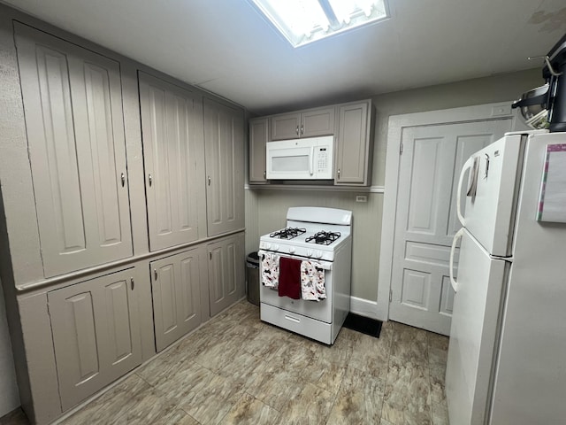 kitchen with white appliances, gray cabinets, and light countertops