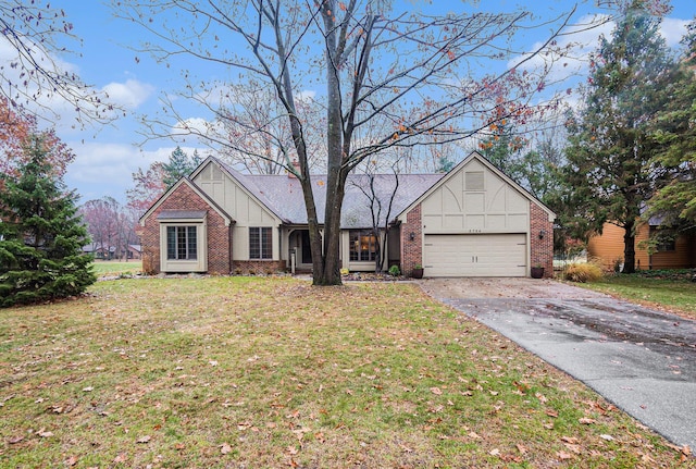 single story home featuring driveway, brick siding, a front lawn, and an attached garage