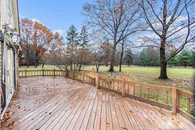 wooden deck featuring a yard