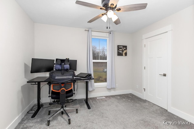 carpeted office with visible vents, ceiling fan, and baseboards