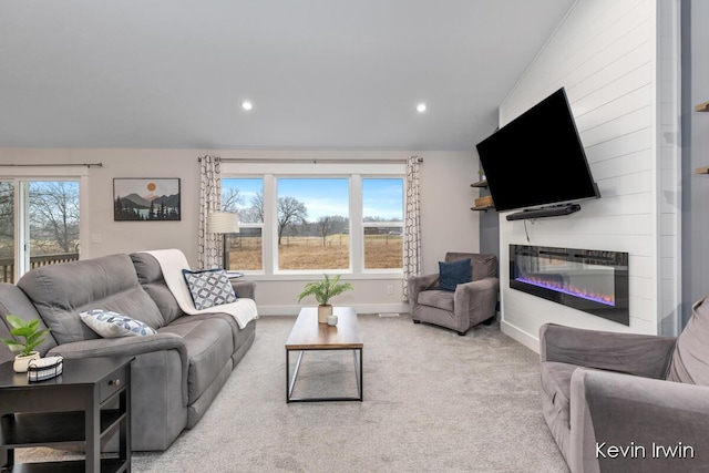 living room with a wealth of natural light, carpet flooring, a fireplace, and recessed lighting