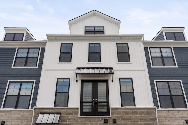 view of front of property featuring a standing seam roof, metal roof, and french doors