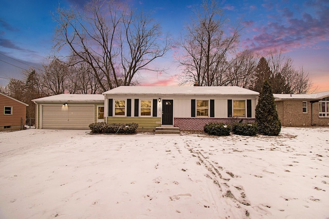 single story home featuring an attached garage and brick siding