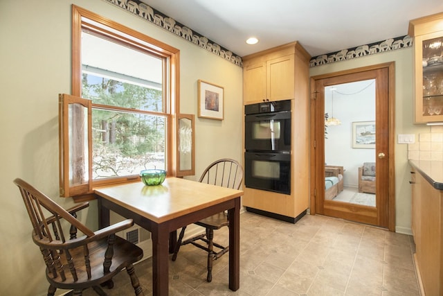 dining area with baseboards and recessed lighting