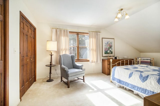 bedroom featuring light carpet, a closet, and lofted ceiling