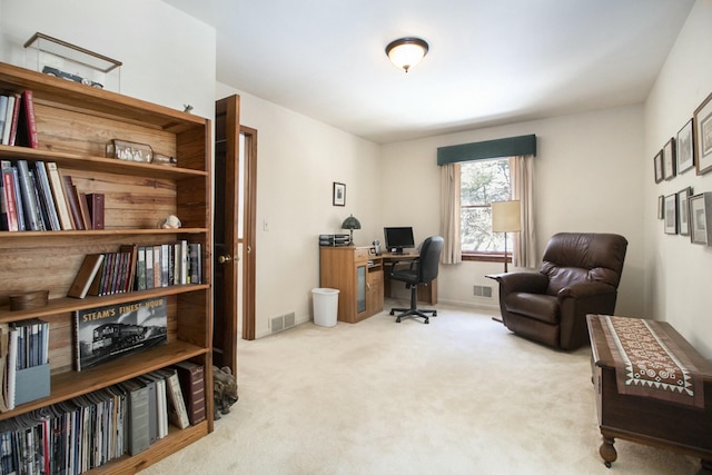 office area with visible vents and light colored carpet