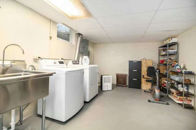 clothes washing area featuring laundry area, washing machine and dryer, and electric panel