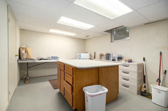 interior space with concrete flooring and a drop ceiling