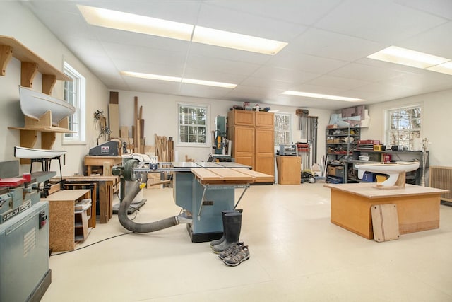 interior space with light floors and a drop ceiling