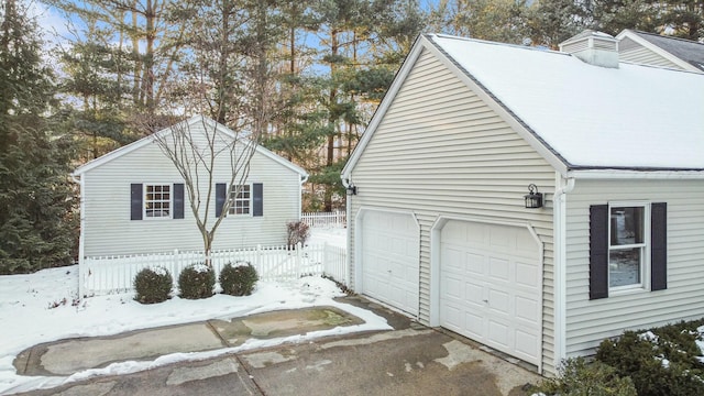 snow covered property with fence