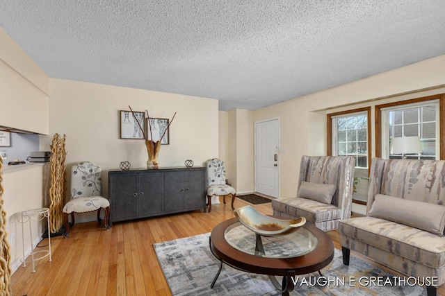 living area featuring a textured ceiling and light wood finished floors