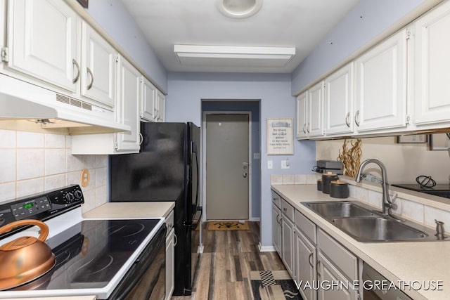 kitchen with light countertops, white cabinets, a sink, and electric range