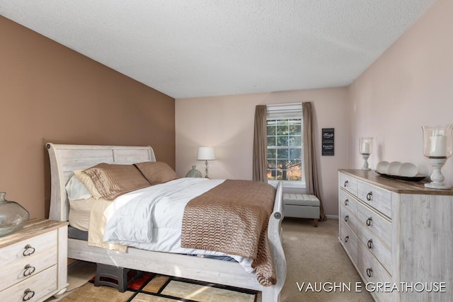 bedroom featuring a textured ceiling and light colored carpet