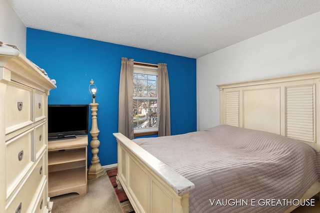 bedroom featuring light carpet and a textured ceiling