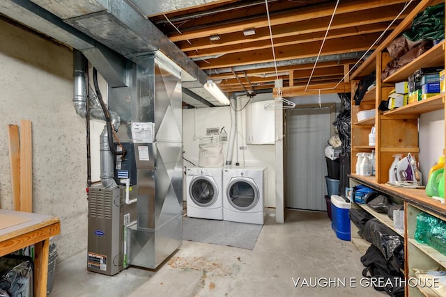 unfinished basement featuring heating unit and independent washer and dryer