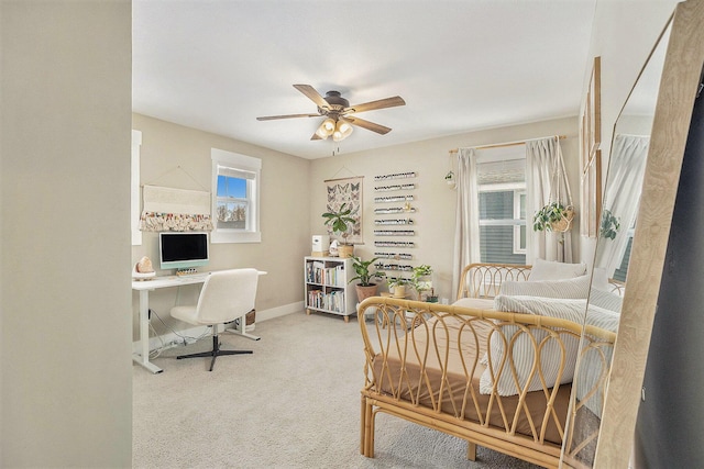 carpeted bedroom with a ceiling fan and baseboards