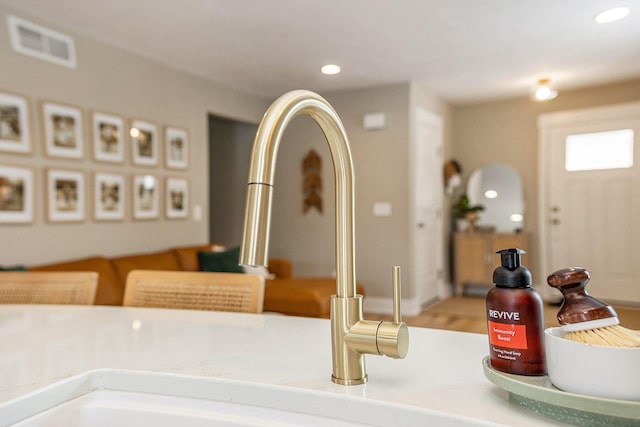 room details featuring light countertops, a sink, visible vents, and recessed lighting