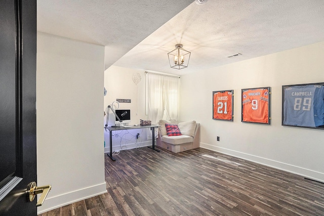 living area with baseboards, a textured ceiling, visible vents, and dark wood-type flooring