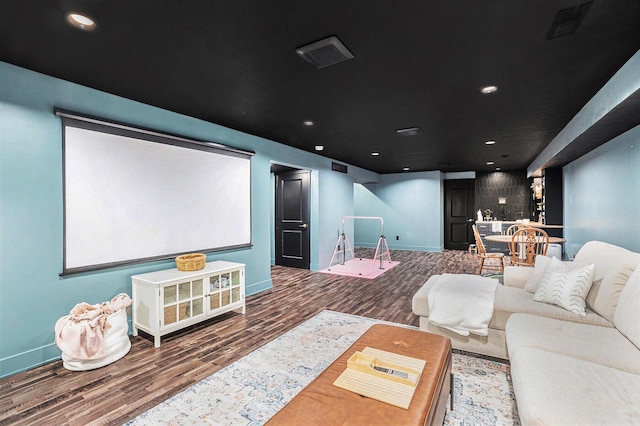 cinema featuring recessed lighting, visible vents, baseboards, and wood finished floors