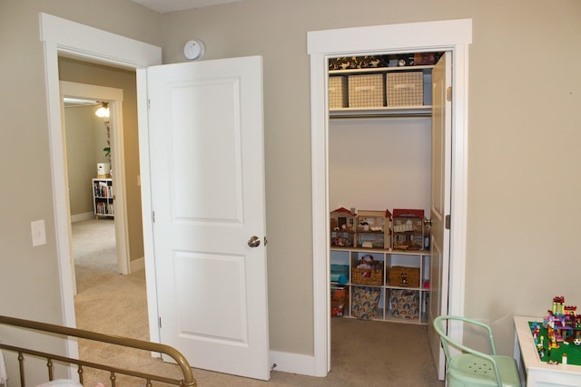 bedroom featuring a closet, baseboards, and carpet flooring