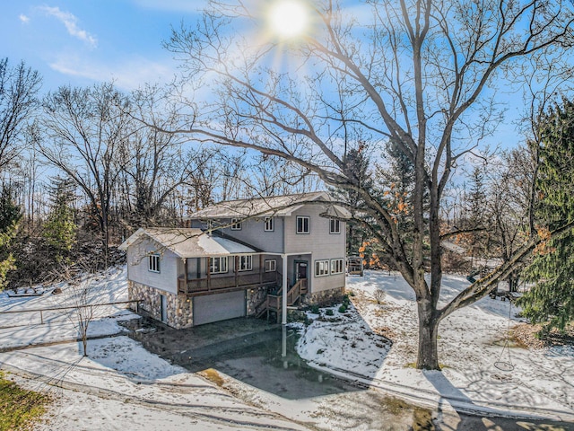 view of front of house with an attached garage and stone siding