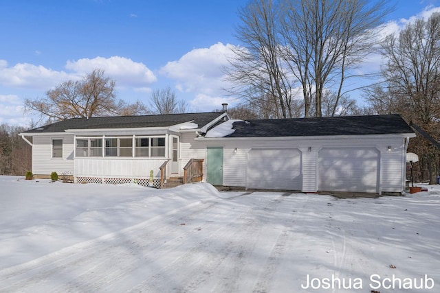 view of front of house featuring a sunroom and an attached garage