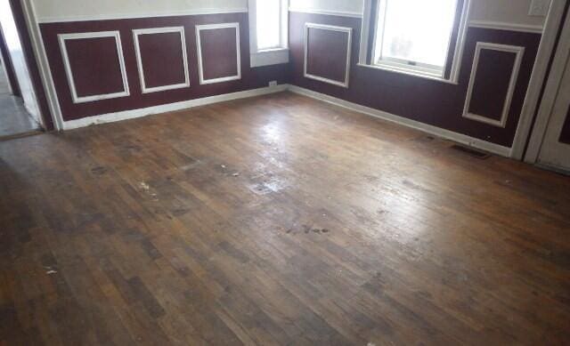 interior space featuring visible vents and dark wood-type flooring