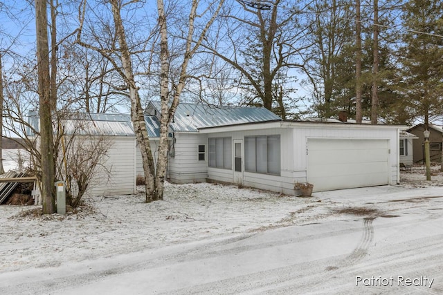 view of front of property featuring metal roof and an attached garage