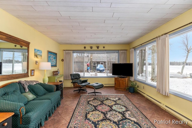 living room with a baseboard radiator, tile patterned flooring, and a healthy amount of sunlight