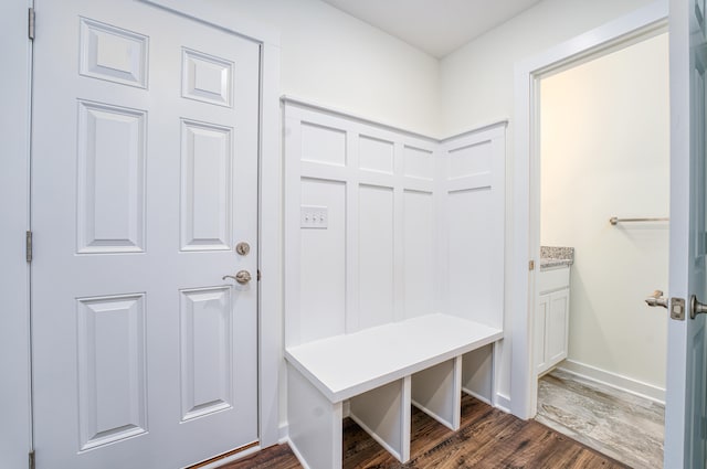 mudroom featuring dark wood-style floors and baseboards