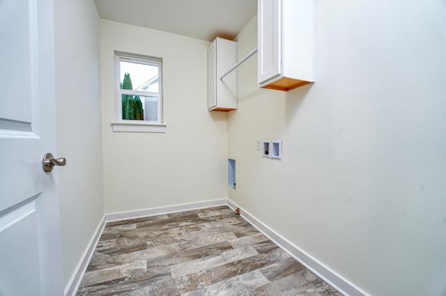 laundry room with cabinet space, baseboards, washer hookup, and wood finished floors