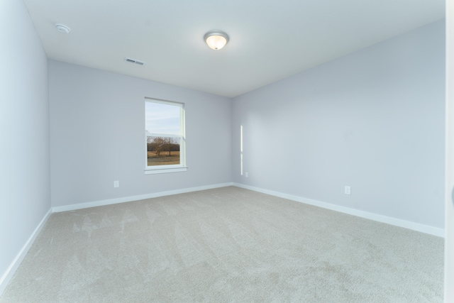 unfurnished room featuring light carpet, baseboards, and visible vents