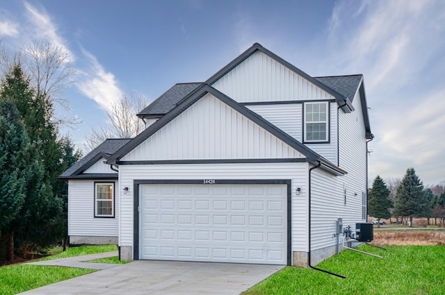 view of front of home featuring a garage, driveway, central AC unit, and roof with shingles