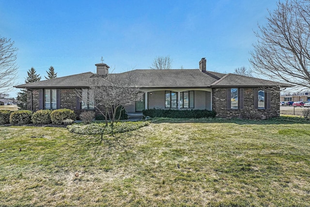 ranch-style house with brick siding, a chimney, and a front lawn