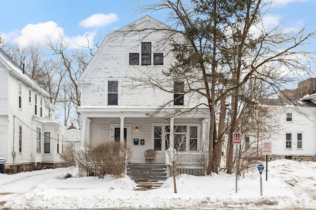 dutch colonial with covered porch and a gambrel roof