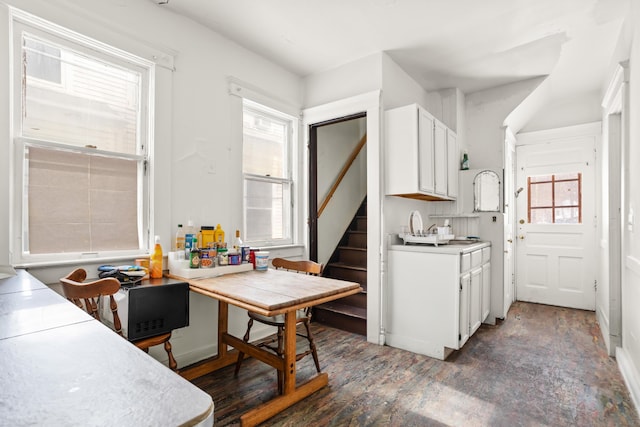 kitchen with light countertops, plenty of natural light, and white cabinetry