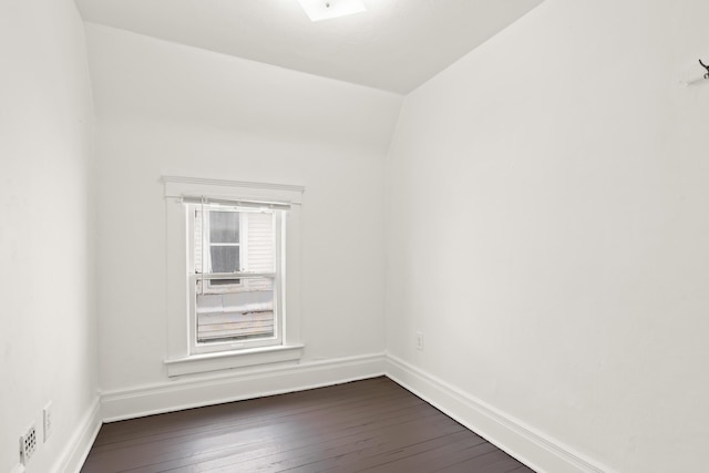 unfurnished room featuring dark wood-style floors and baseboards