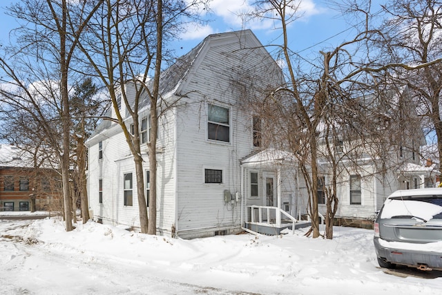 colonial inspired home featuring a garage and a gambrel roof