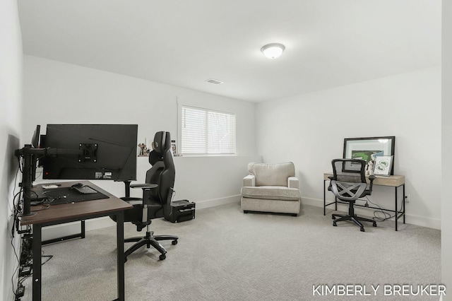 carpeted office with visible vents and baseboards