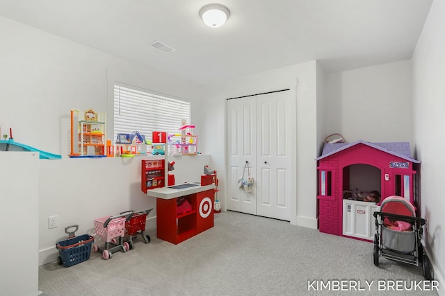 recreation room with carpet floors and visible vents