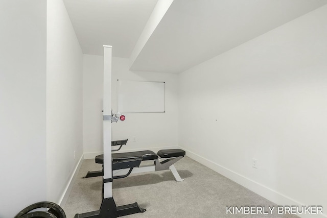 workout area with light colored carpet and baseboards