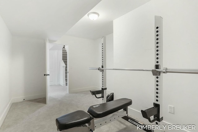 workout area with light carpet and baseboards