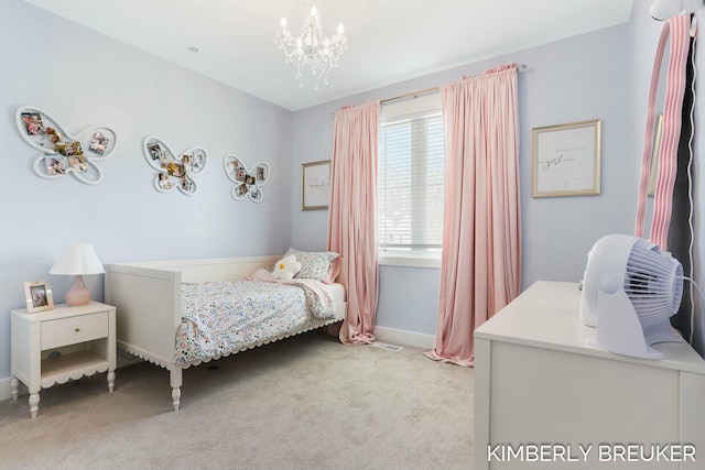 carpeted bedroom with baseboards and an inviting chandelier