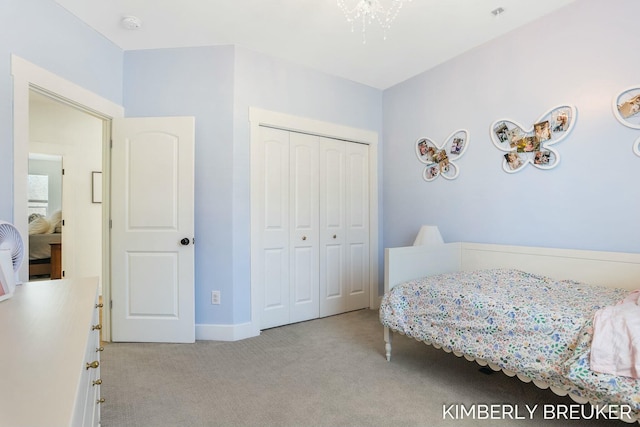 bedroom with a closet and light colored carpet