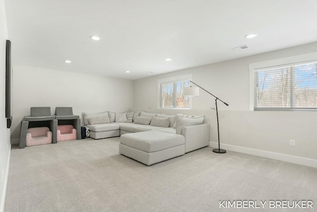 living area featuring light carpet, recessed lighting, visible vents, and baseboards