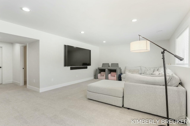 carpeted living room featuring baseboards and recessed lighting