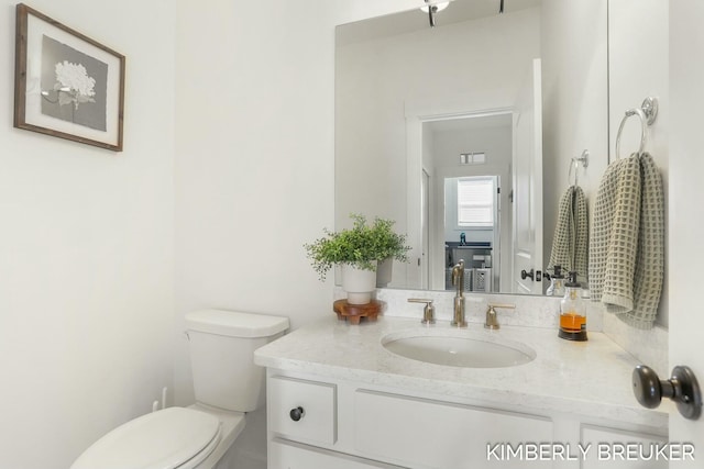 bathroom with vanity and toilet