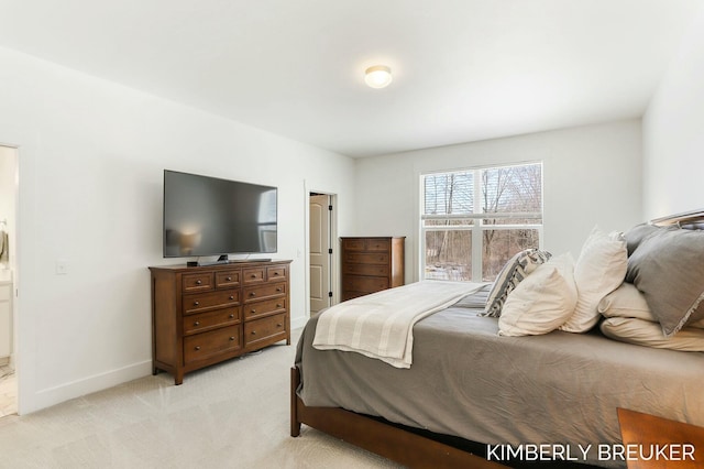 bedroom featuring light carpet and baseboards